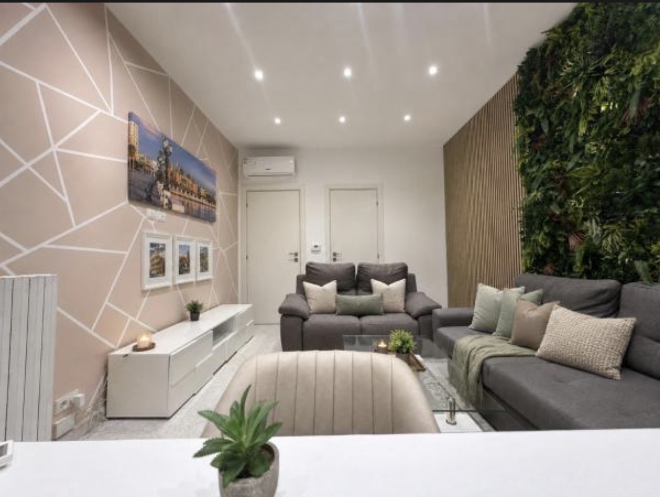 The Urban Lodge living room with sofas and green wall